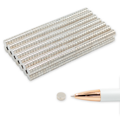Neodymium disc magnets N42 Ø8 × 3 mm, nickel-plated, stacked next to a ballpoint pen for size comparison